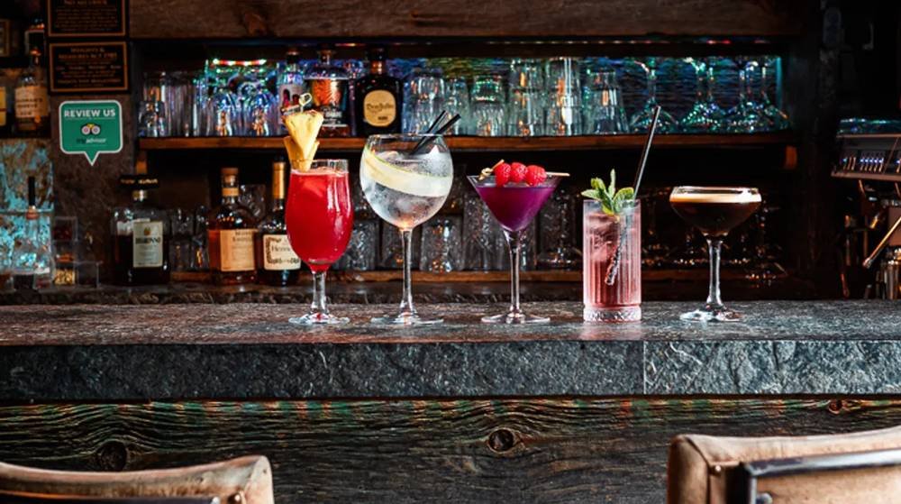 A line-up of five cocktails along the bar at Park's Edge